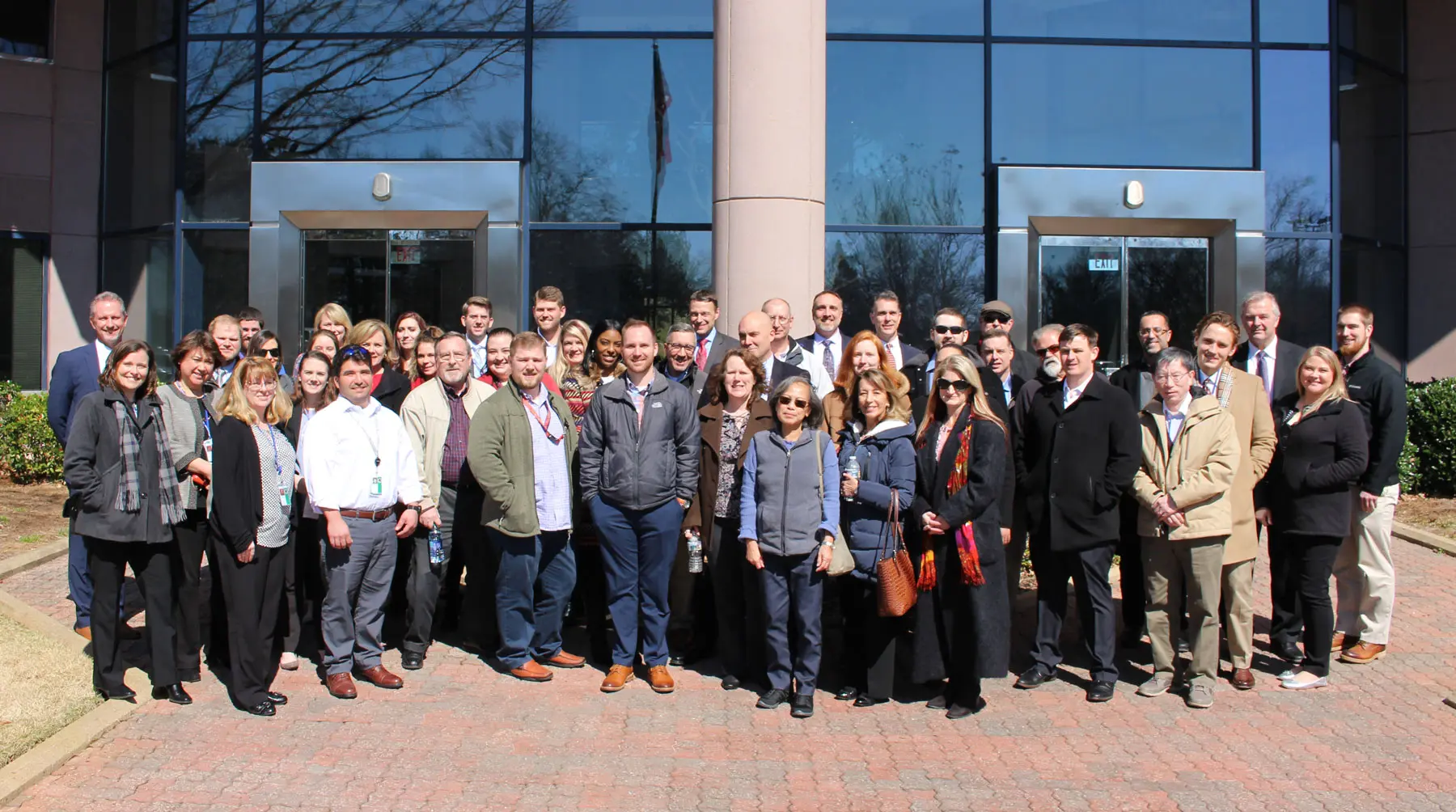 Group photos of employees in front of MDW building